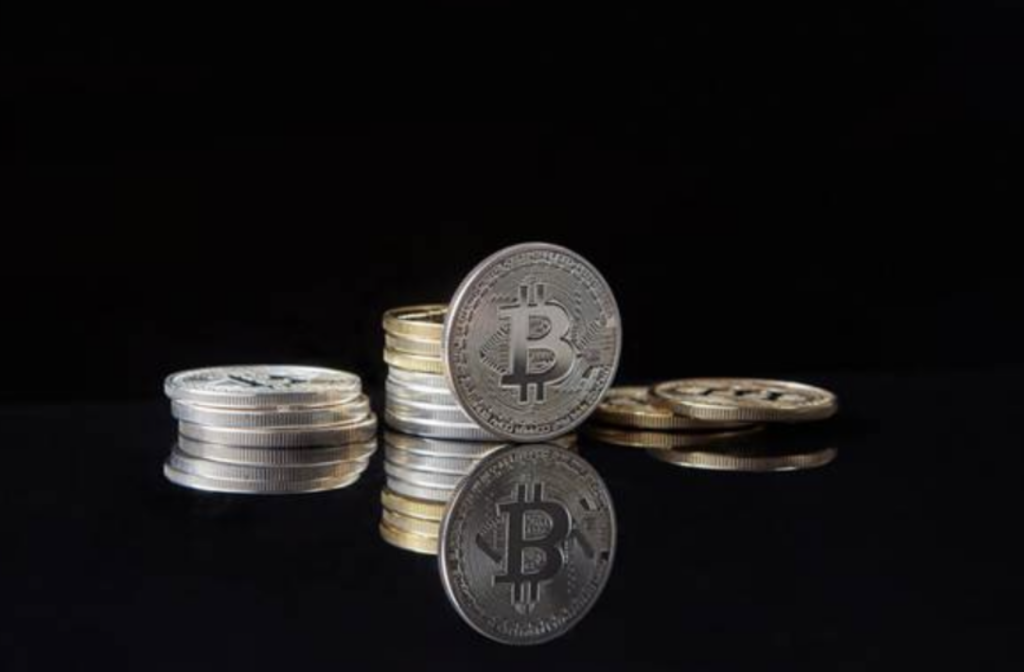 Silver crypto coins on dark surface